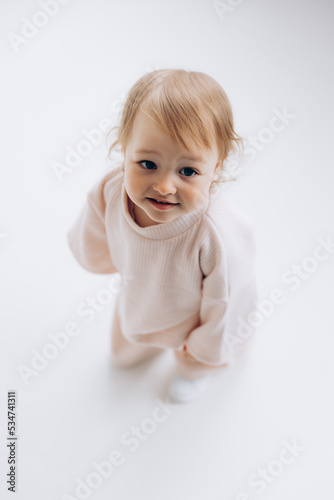 29.04.22 Kyiv, Ukraine: little stylish girl of one and a half years poses for a photo on a white studio cyclorama