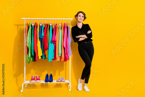 Photo of funny confident girl dressed formal shirt arms crossed working showroom empty space isolated yellow color background