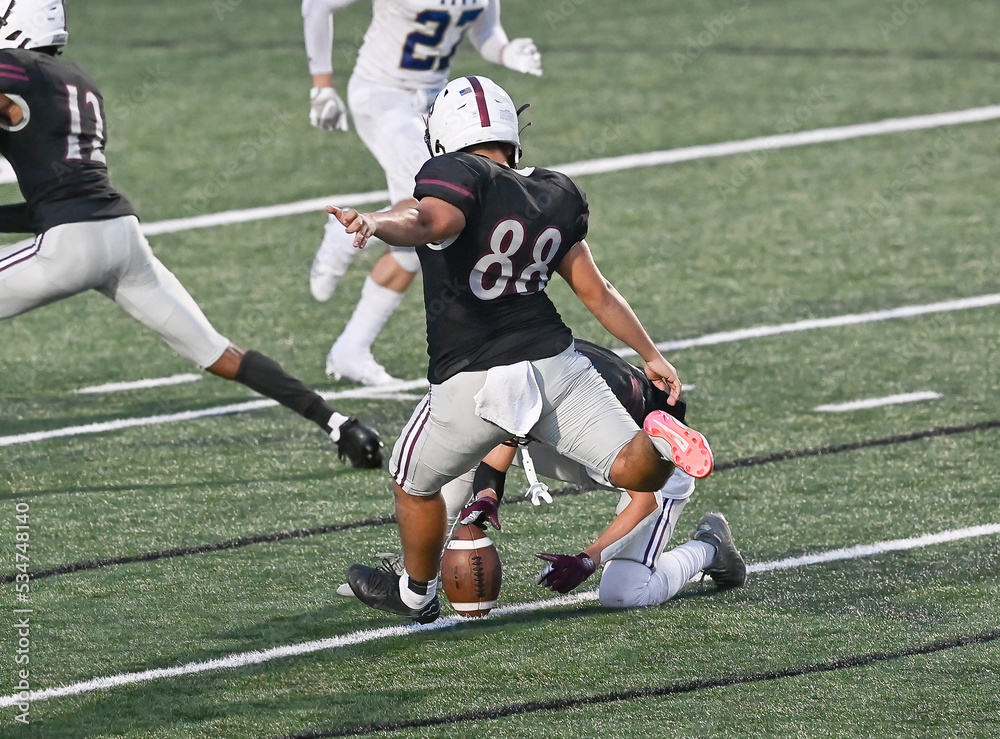 Young athletic tackle football players making great plays during a game Young athletic tackle football players making great plays during a game