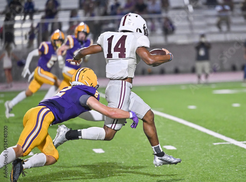 Young athletic tackle football players making great plays during a game