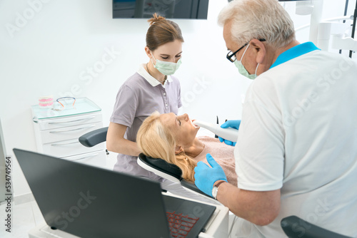 Woman on examination after treatments in dental cabinet