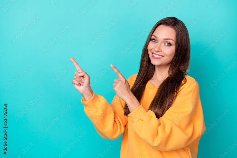 Photo of positive lady point hand empty space demonstrate ads isolated on cyan color background Photo of positive lady point hand empty space demonstrate ads isolated on cyan color background