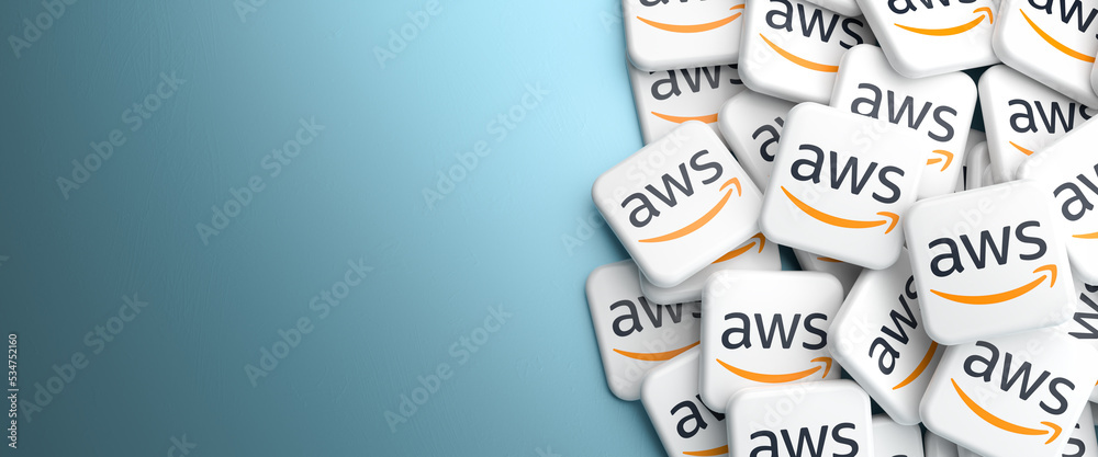 Logos of the Amazon cloud services AWS on a heap on a table. Web banner format with copy space.