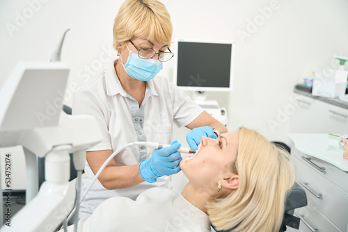 Adult girl sitting in the dentist's chair