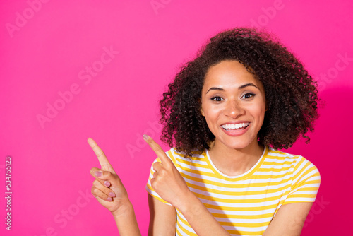 Close up photo of lovely young lady point up shopping empty space banner wear stylish striped look isolated on vivid pink color background