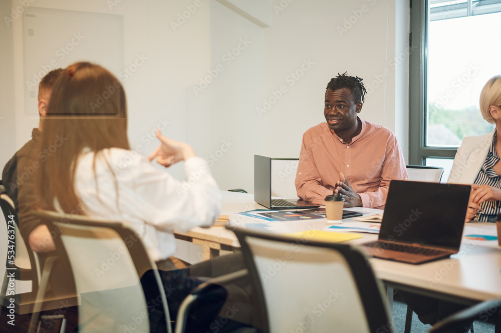 Multiracial business team having a meeting in the office Multiracial business team having a meeting in the office