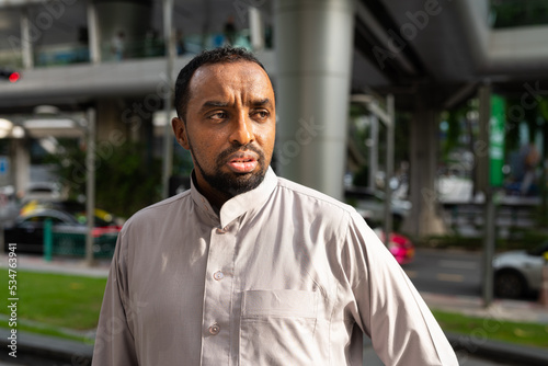 Bild auf Leinwand Portrait of handsome black man in city wearing traditional clothes
