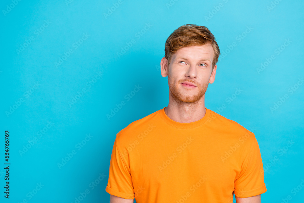 Photo of thoughtful handsome guy with ginger hairstyle dressed yellow t-shirt look empty space isolated on turquoise color background Photo of thoughtful handsome guy with ginger hairstyle dressed yellow t-shirt look empty space isolated on turquoise color background