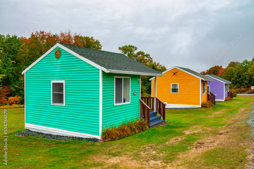 Colorful wooden homes in a foliage landscape, autumn season Colorful wooden homes in a foliage landscape, autumn season
