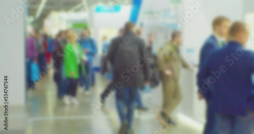 modern business life. defocused blurry video. background on the theme of business. blurred silhouettes of unrecognizable people walking in a large hall. photo