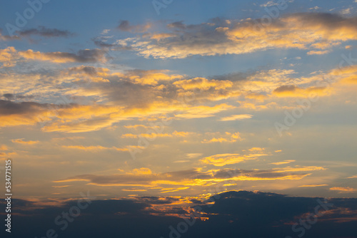 Golden clouds on blue sunset sky. Perfect evening sky background