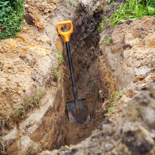 Shovel in the trench. The concept of earthworks. photo