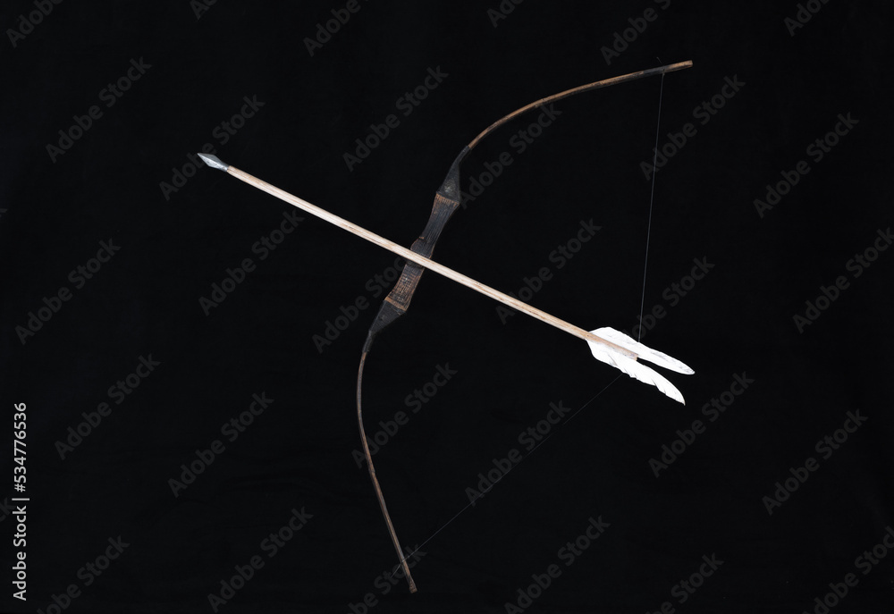 Fototapeta premium wooden hunting bow on a black background