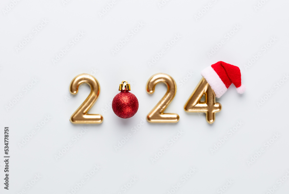 New year 2024 number, golden digits and santa hat over blue background.