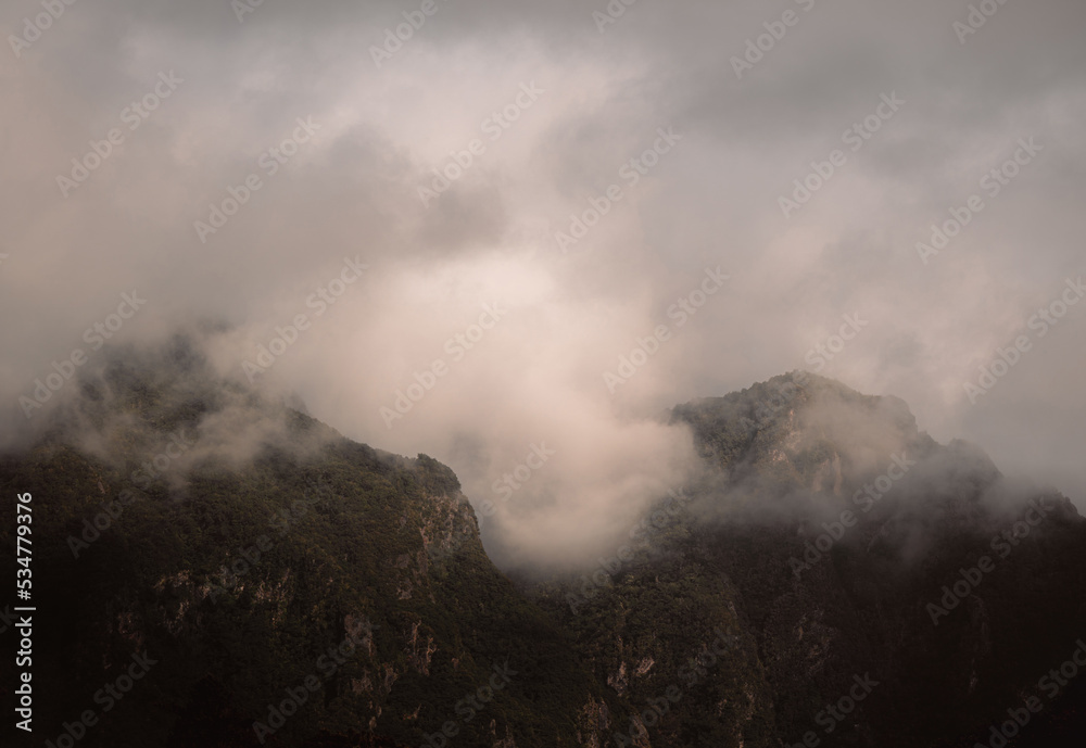 Dramatic clouds over mountains, moody landscape, copy space, Madeira