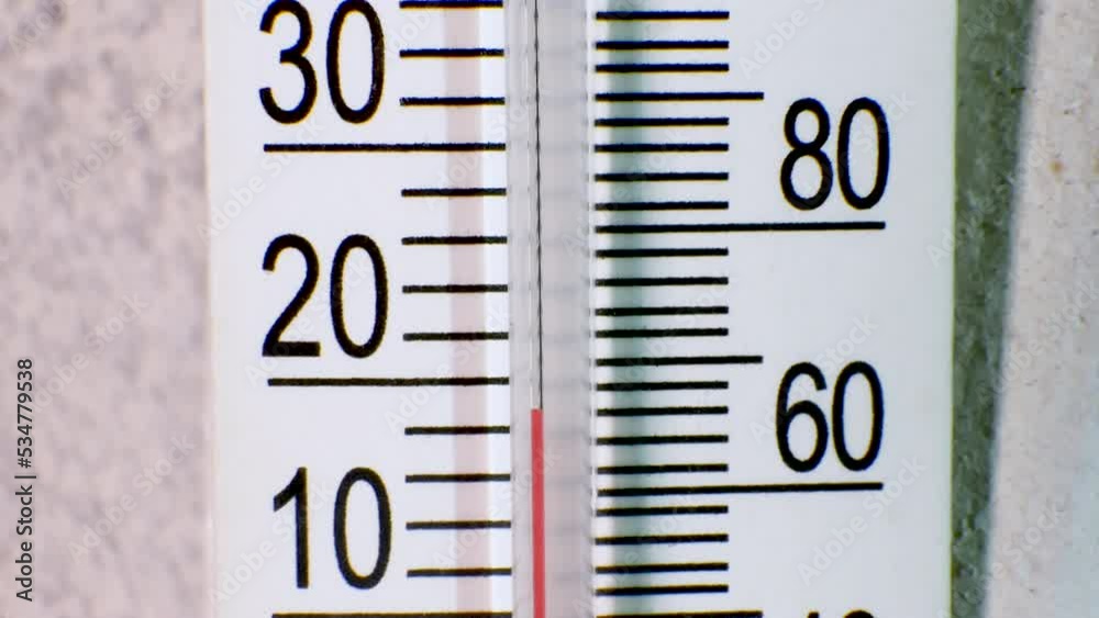 Changing of the climate. A mercury thermometer indicates a drop in