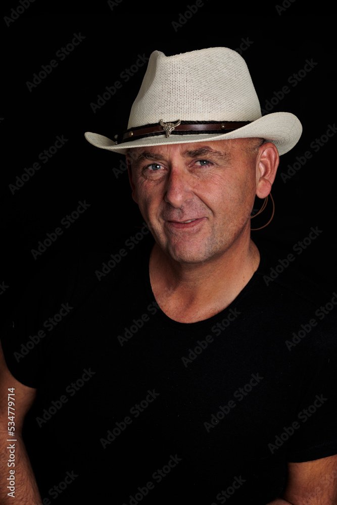 photography man over 50 years old with hat on black background photography man over 50 years old with hat on black background