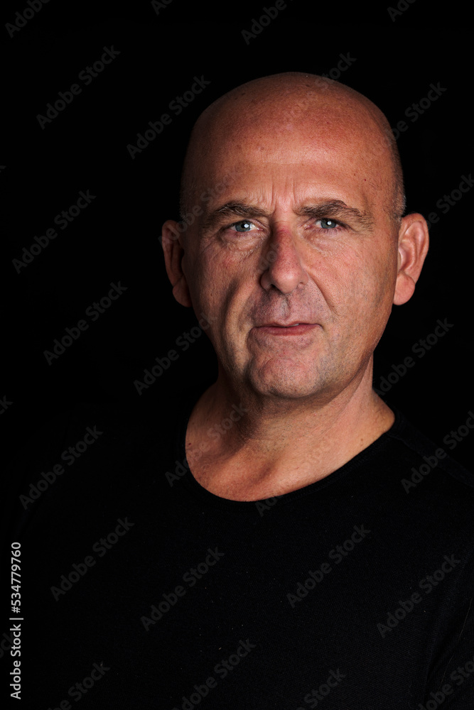 photograph man over 50 years bald with black background photograph man over 50 years bald with black background