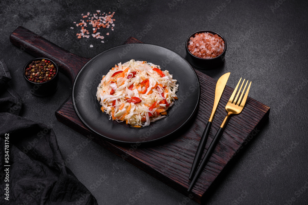 A delicious fresh vegetarian salad of white cabbage, carrot and paprika A delicious fresh vegetarian salad of white cabbage, carrot and paprika