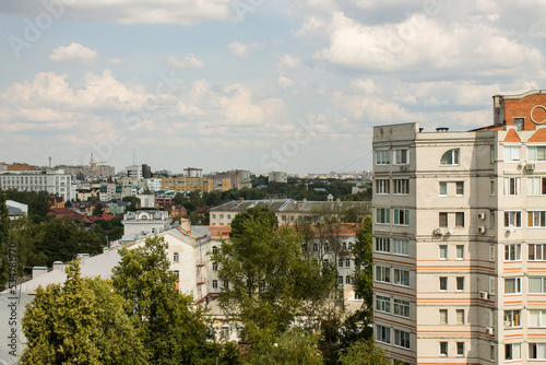 Panoramic top view of residential buildings among the lush green foliage of trees in Vladimir russia in the a cloudy summer day and a copy space © Inna