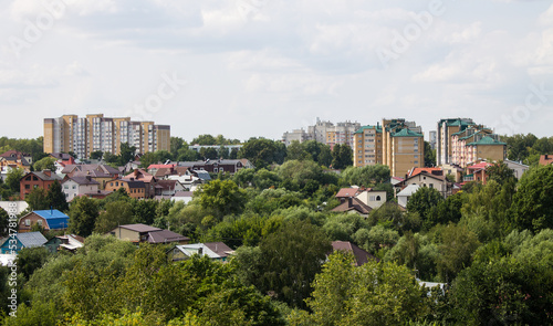 Panoramic top view of residential buildings among the lush green foliage of trees in Vladimir russia in the a cloudy summer day and a copy space