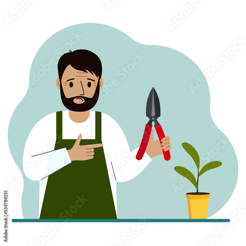 A gardener is a man in working clothes, he has a pruner in his hand.