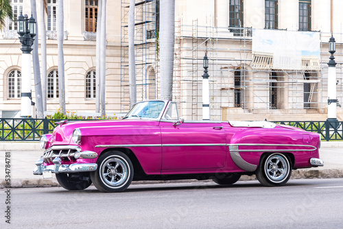 vintage purple classic car on the street of havana cuba
