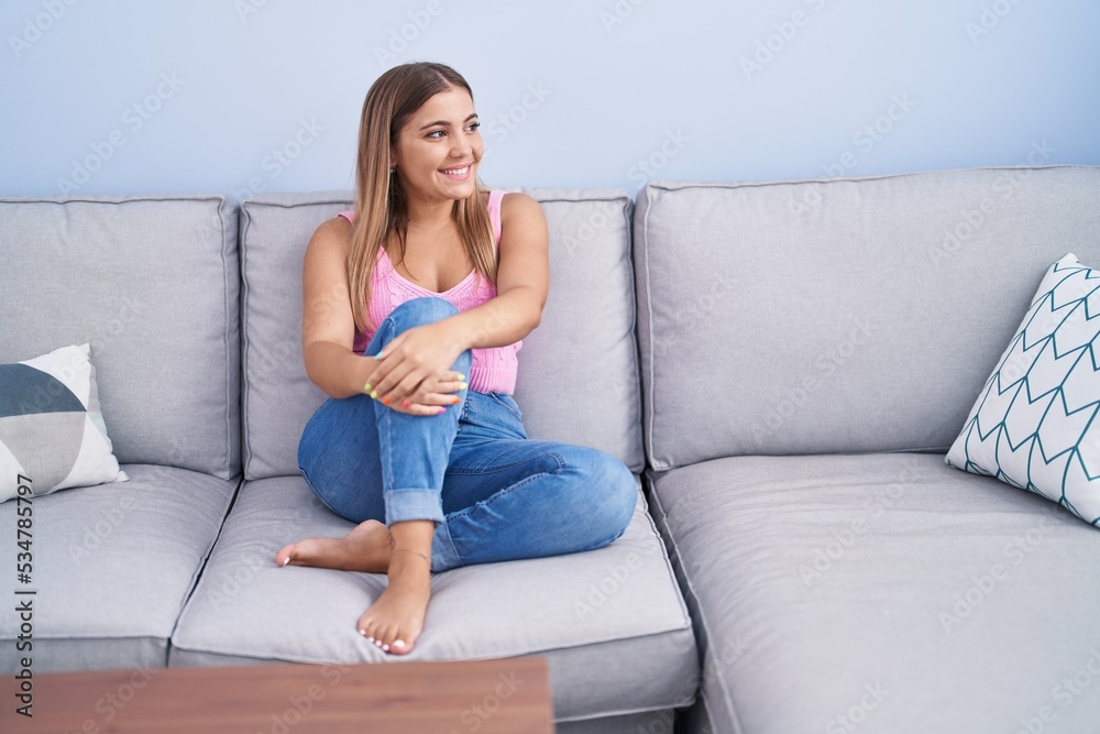Young beautiful hispanic woman smiling confident sitting on sofa at home Young beautiful hispanic woman smiling confident sitting on sofa at home