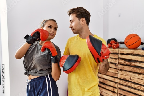 Man and woman couple concentrate boxing at sport center