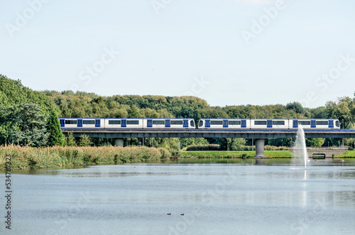 Rotterdam, The Netherlands, September 22, 2022: a metro train crossing Zuiderpark on a concrete viaduct