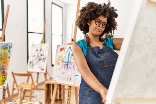Young african american woman looking draw at art studio