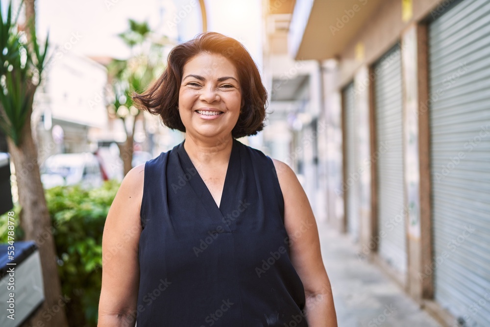 Middle age hispanic woman smiling happy and confident outdoors on a sunny day Middle age hispanic woman smiling happy and confident outdoors on a sunny day
