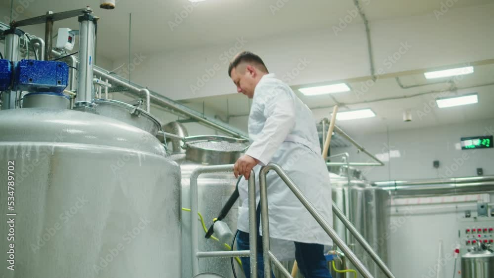 Craft beer production, general cleaning on factory, brewery manufacture. Washing metal vats bottles. Brewing, cooking alcohol. Craft beer production, general cleaning on factory, brewery manufacture. Washing metal vats bottles. Brewing, cooking alcohol.