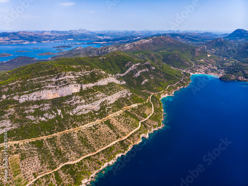 aerial view of the peljesac peninsula in croatia; paradise beaches with turquoise water and rocky coastline; mighty mountains over the mediterranean sea; peljesac bridge; croatian adriatic coastline