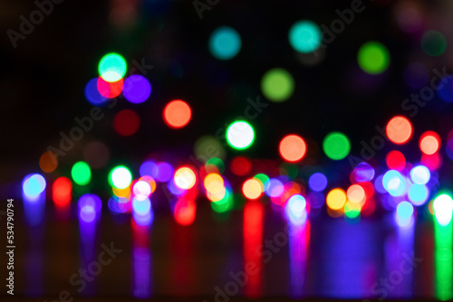 Abstract background with colorful sparkling bokeh on a dark background. Holiday concept