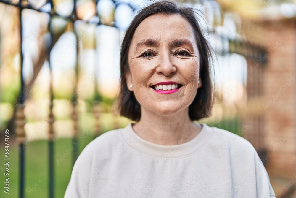 Middle age woman smiling confident standing at park Middle age woman smiling confident standing at park