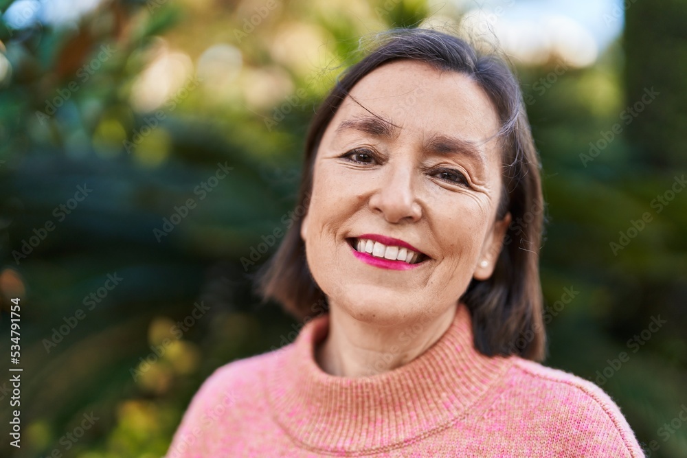 Middle age woman smiling confident standing at park Middle age woman smiling confident standing at park