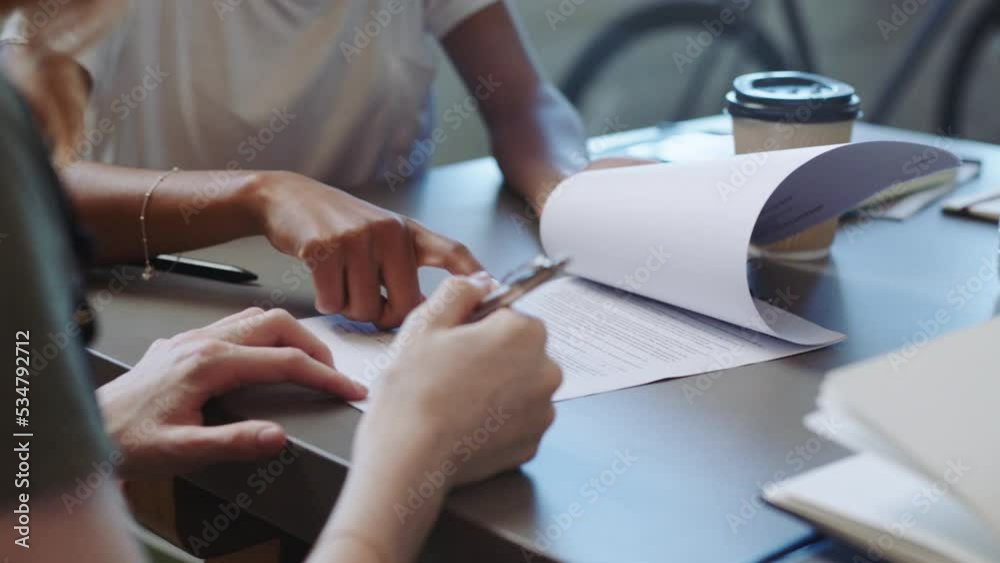 Hands of lawyer and client review contract, agreement or paperwork for marriage divorce settlement. Consultation, family law and legal expert with documents consulting woman and gesture for signature
