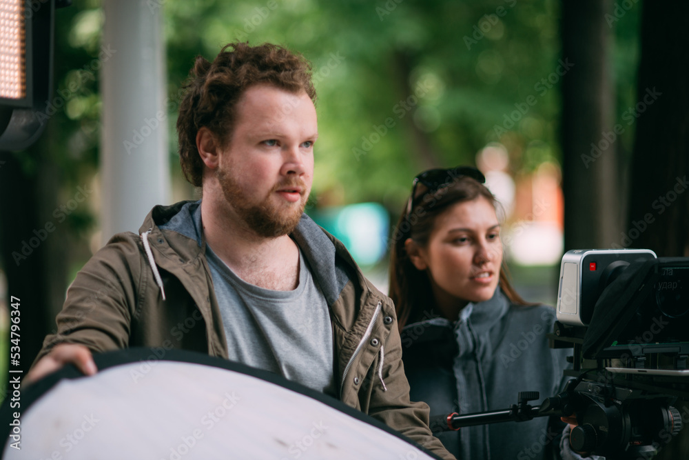 Fototapeta premium Director of photography with a camera in his hands on the set. The filming process on the street, on location