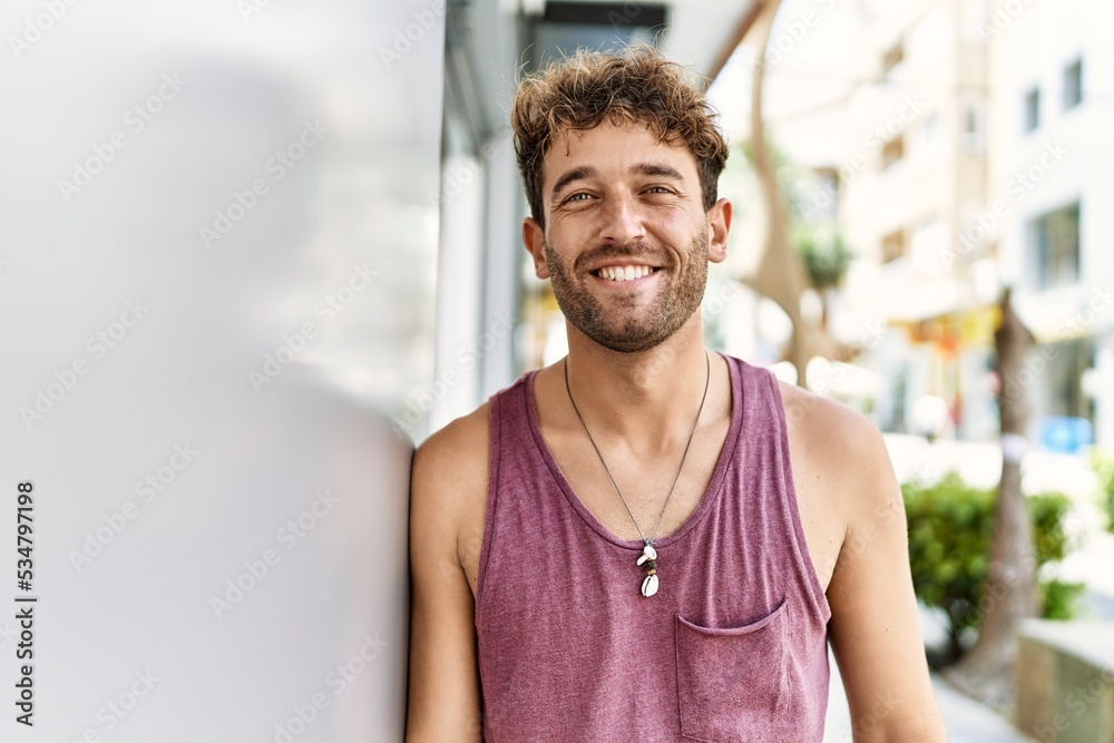 Young hispanic man smiling confident leaning on wall at street Young hispanic man smiling confident leaning on wall at street