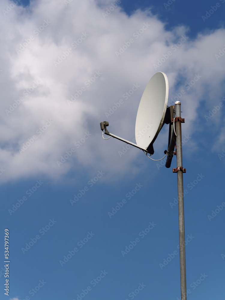 Closeup view of a home satellite dish shot against sky Closeup view of a home satellite dish shot against sky