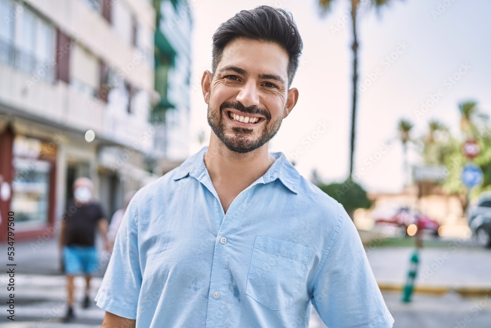 Young hispanic man smiling happy standing at the city. Young hispanic man smiling happy standing at the city.