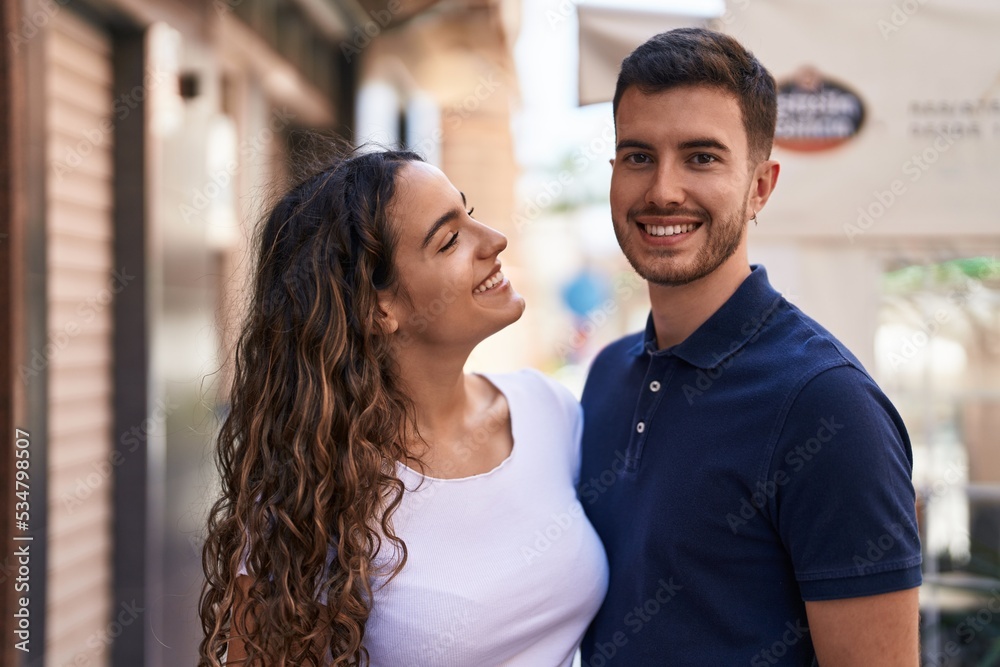 Young hispanic couple smiling confident hugging each other at street Young hispanic couple smiling confident hugging each other at street