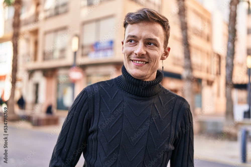 Young man smiling confident looking to the side at street Young man smiling confident looking to the side at street