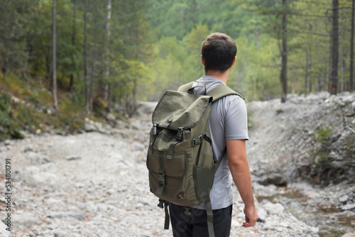 Faceless portrait of man tourist hiking in the forest. Adventure and active lifestyle in nature