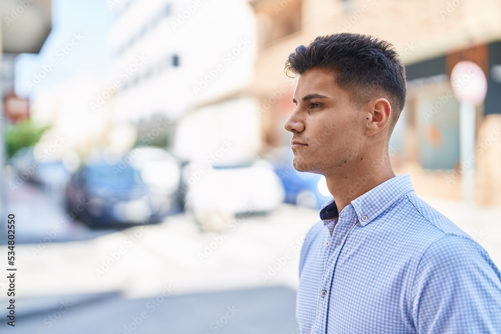 Young hispanic man standing with relaxed expression at street Young hispanic man standing with relaxed expression at street