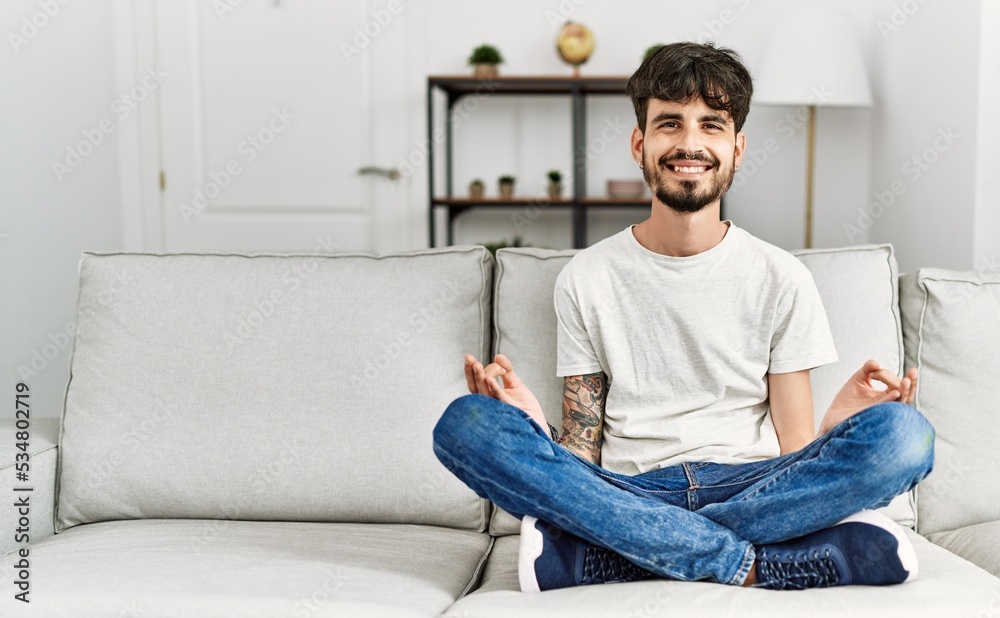 Young hispanic man smiling confident meditating at home Young hispanic man smiling confident meditating at home