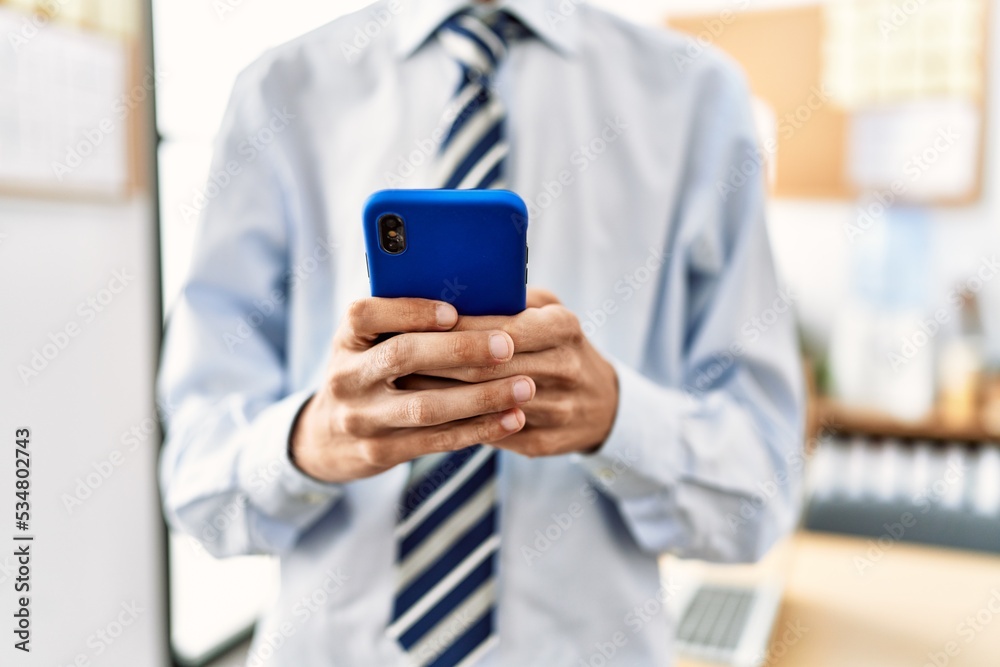 Businessman using smartphone working at the office.