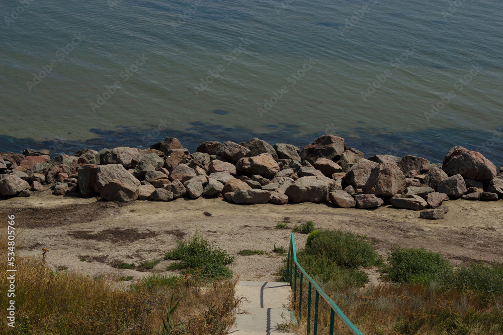 Fototapeta premium Stairs leading to the sea. Rocky coast of the Sea of Azov.