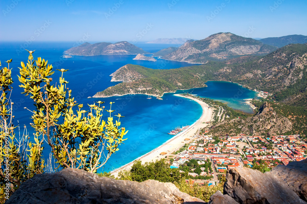 Summer scenery of blue lagoon with white sand located in the city Oludeniz. Beautiful view on summer sea and the town from top moutain.